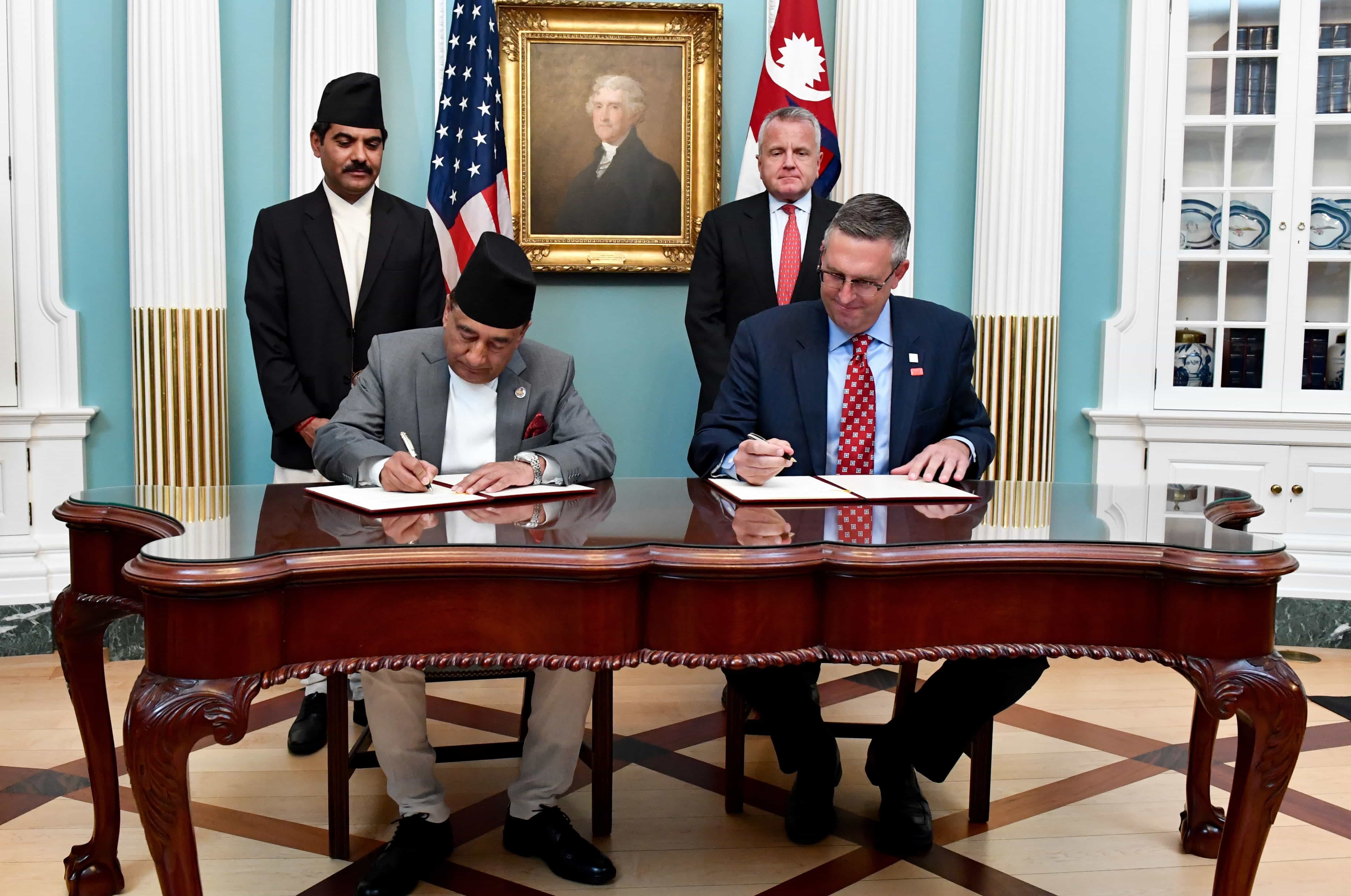 Deputy Secretary of State John Sullivan and MCC’s Acting CEO Jonathan Nash along with Nepal’s Minister of Finance Gyanendra Bahadur Karki at the U.S. Department of State signing the compact on September 14, 2017 | Source: State Department Photo/ Public Domain