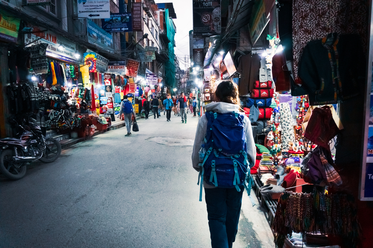 Picture of young woman walking along the street in Thamel neighborhood | Photo by Cristina Moliner on istockphotos by Getty