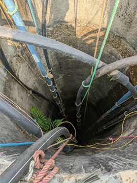 Looking down into a drying well in Madhesh, where the sinking water table during the pre-monsoon season adds hours of labor to a woman’s daily routine