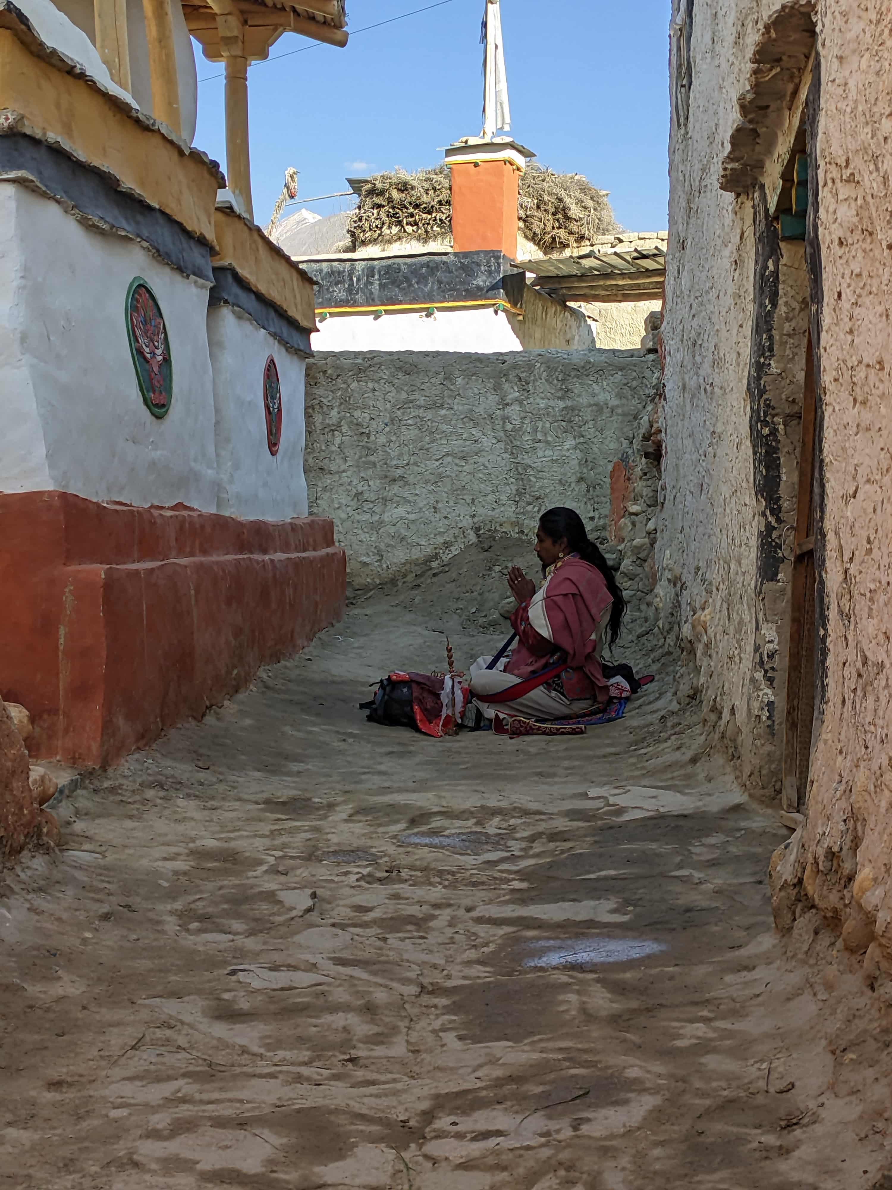The clean streets of Lo Manthang and a priest worshipping the chorten