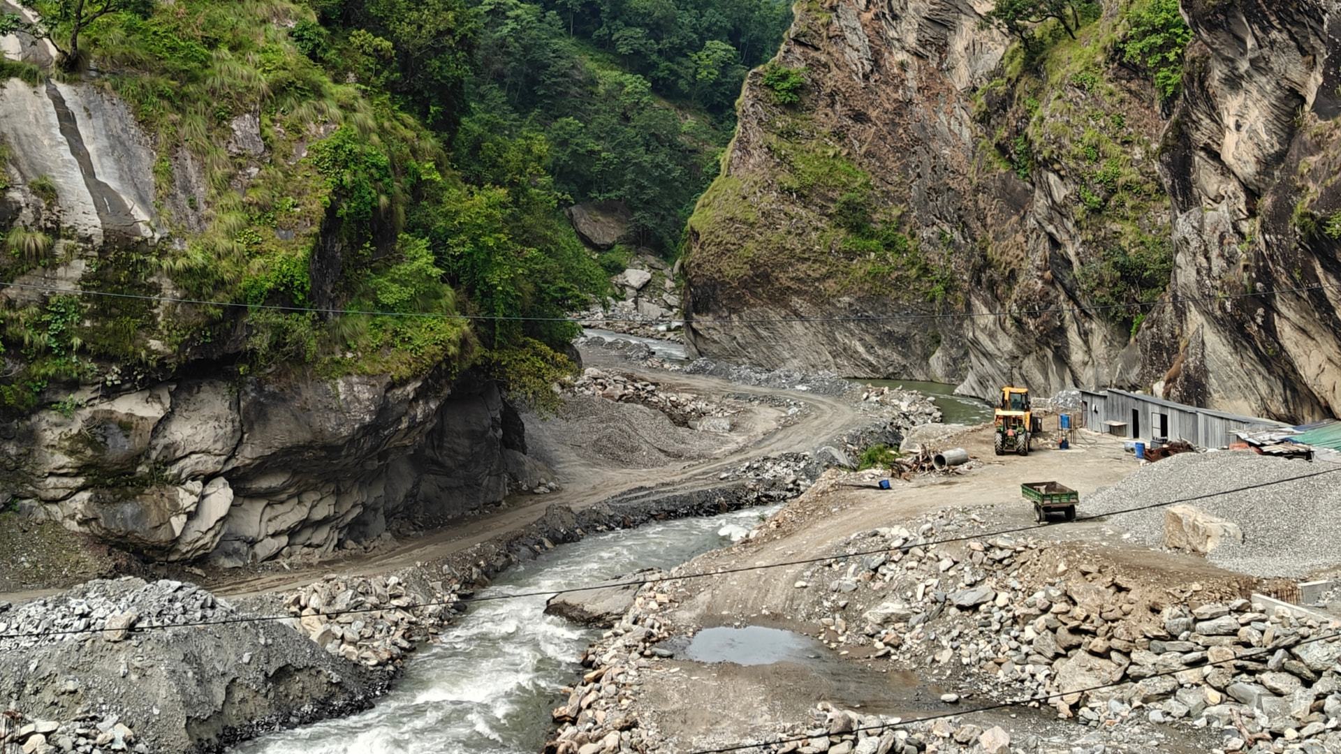 Hydropower construction and river diversion between Borang and Lapa, framed by Ruby Valley's steep hillsides.