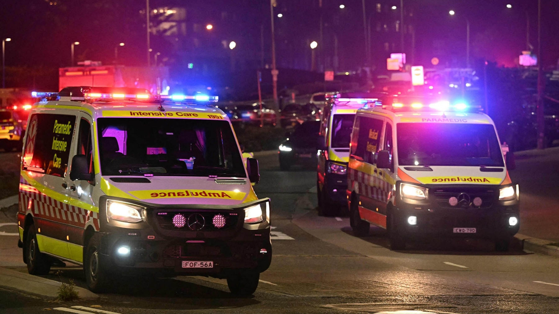 Ambulances on a street after a shooting incident at Bondi Beach in Sydney on December 14, 2025 | Photo: Saeed Khan/AFP